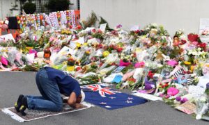 A man prays at a makeshift memorial at Al Noor Mosque in Christchurch