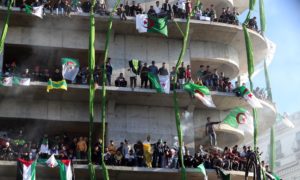 Protesters gather on a building in Algiers.