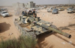 Libyan forces allied with the UN-backed government move with a tank towards Isis fighters